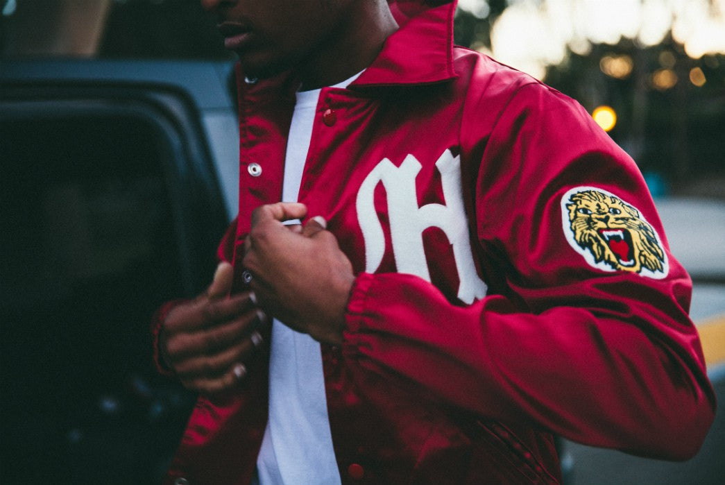 A bright red Ebbets Jacket with a lion on the sleeve and white lettering.