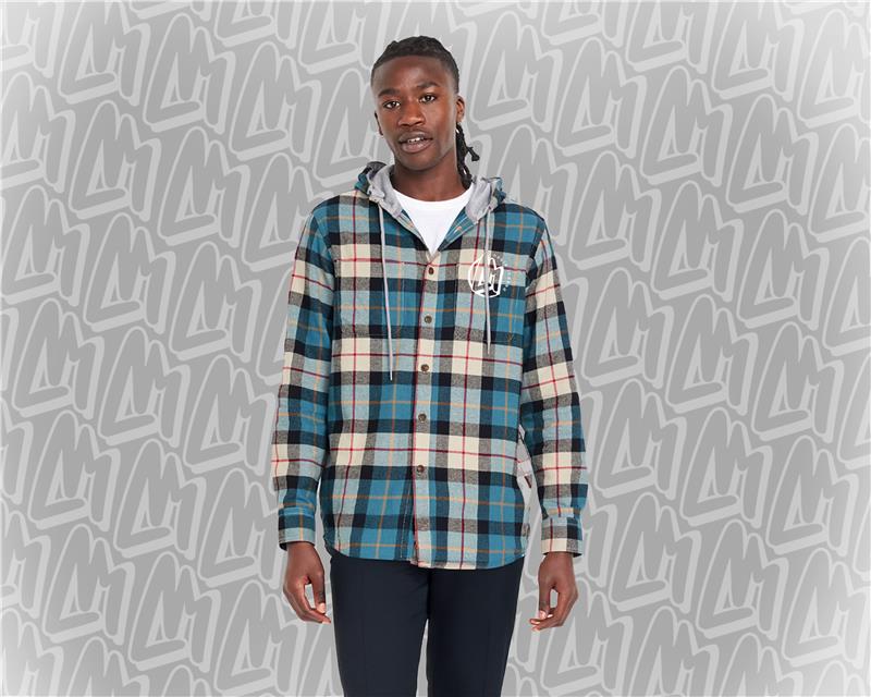 A young man wearing a blue, black, and tan flannel shirt hoodie, the NobleIndeed logo in white on the top left of the shirt chest.