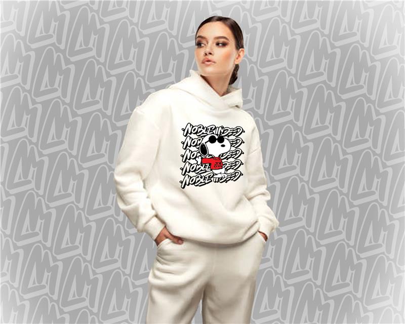 A young woman wearing a white hoodie with Joe Cool, the Snoopy character, with the NobleIndeed logo behind him, on the chest.